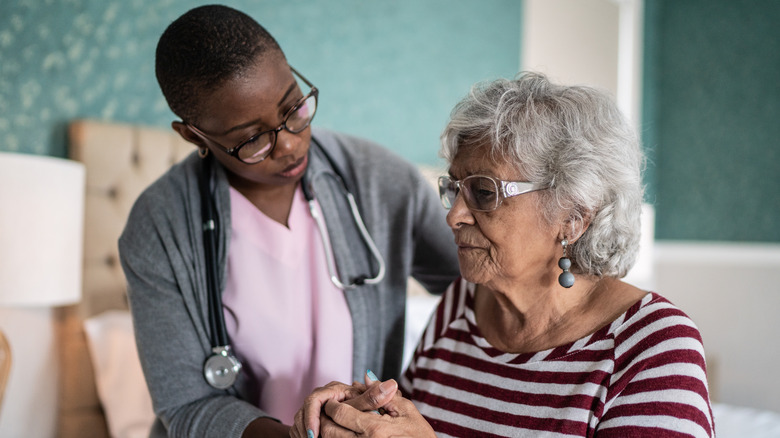 caregiver helping senior woman