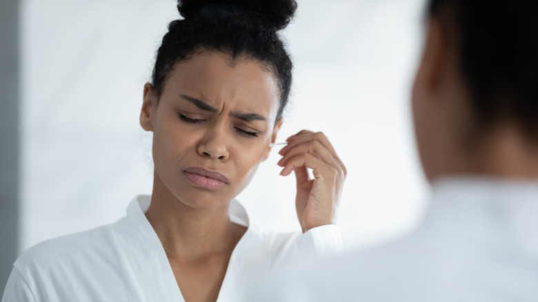 woman cleaning ears