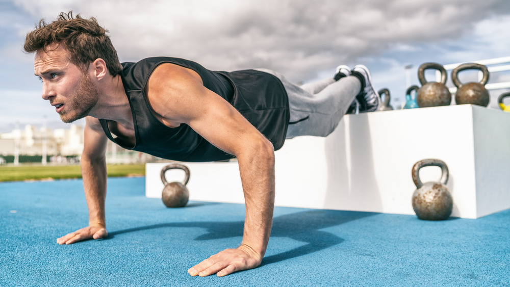 Man doing decline pushups outdoors