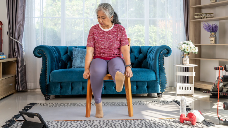 Woman doing single-seated leg raises