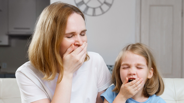 two people yawning
