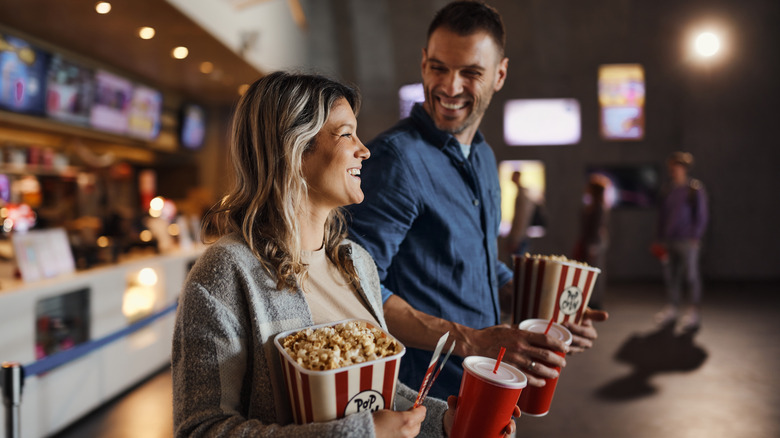 Laughing couple at movie theater