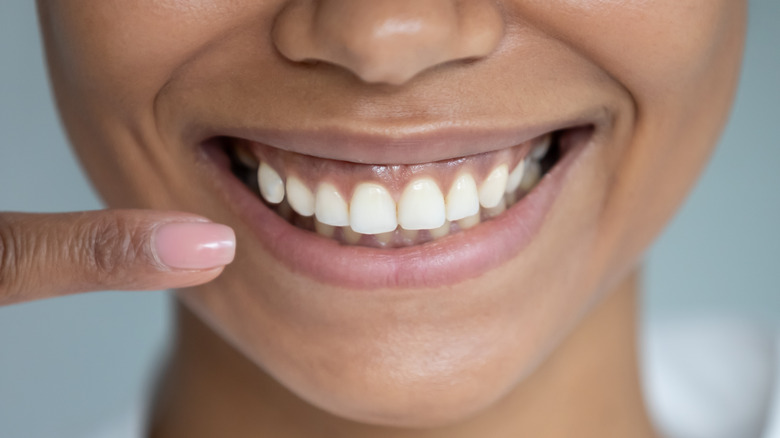 Woman pointing at smile