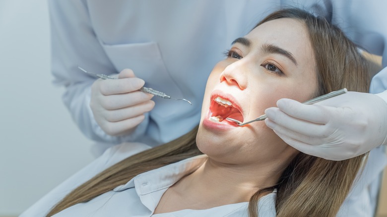dentist examining woman's mouth