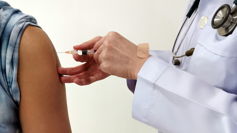 Doctor administering vaccine in someone's arm