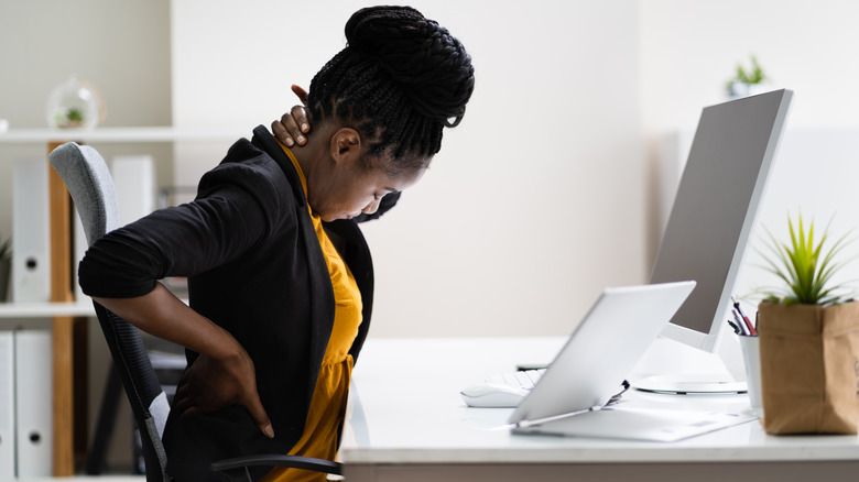 back pain woman sitting at desk