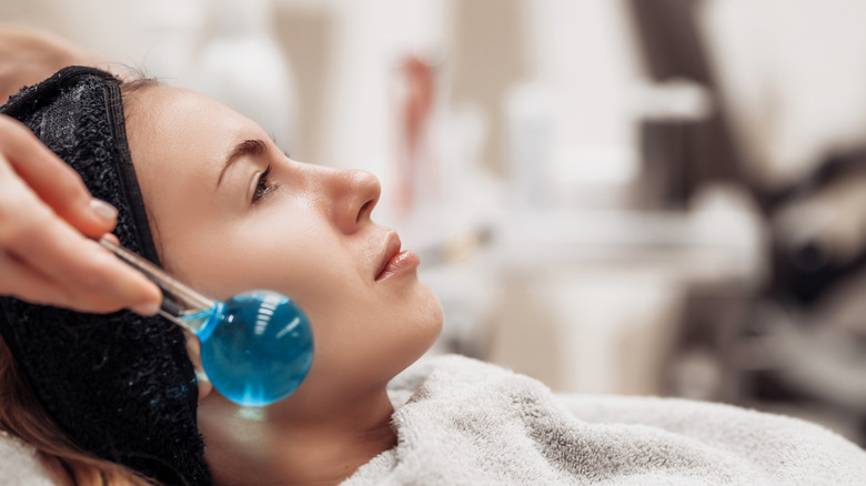 Ice roller near jaw and cheekbones
