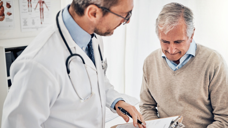older man talking with a doctor