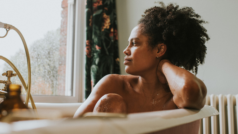 woman in bathtub looking relaxed