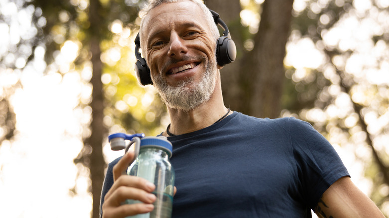 Smiling man with bottled water