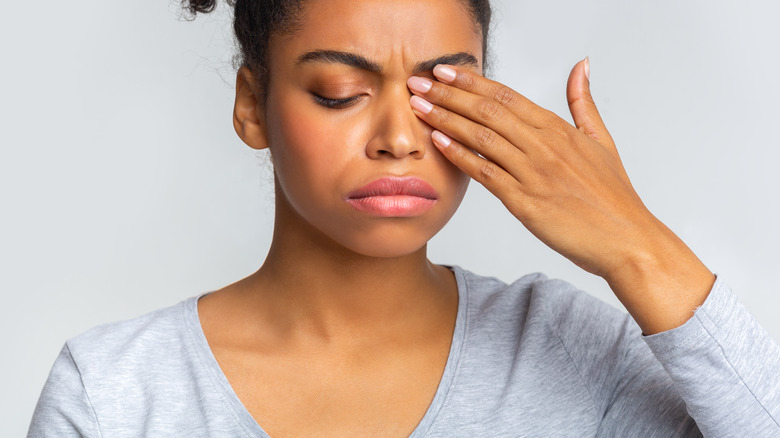 Woman rubbing her eye