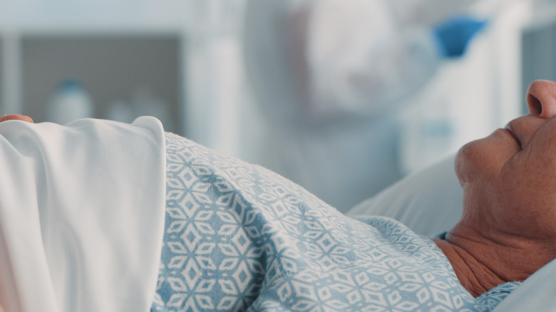 Woman lying in hospital bed