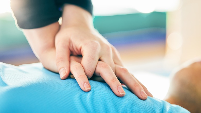 Hands performing chest compressions 