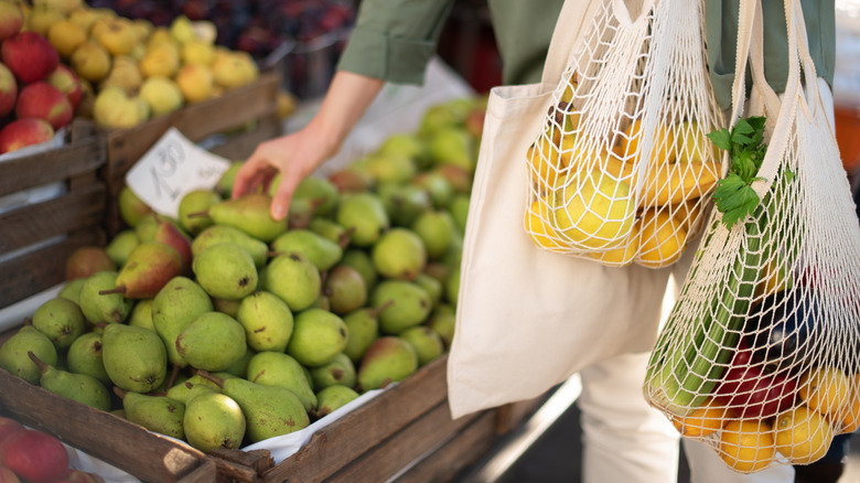 Woman picking fruit at farmer's market