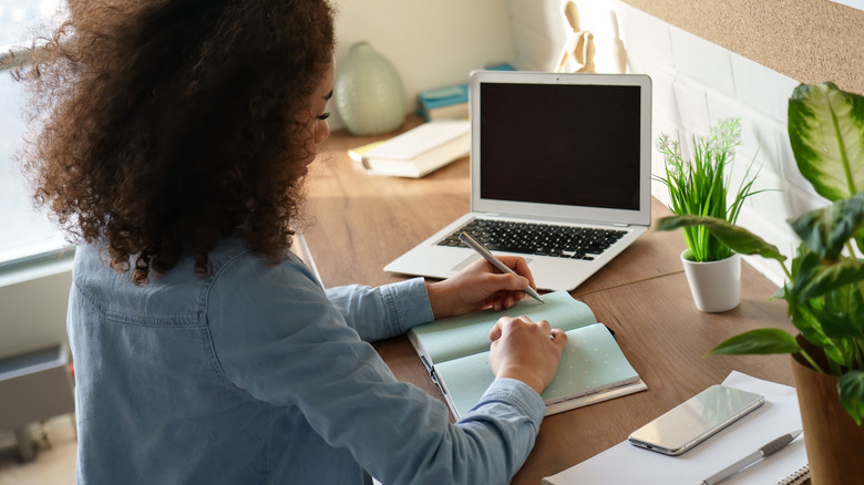 Woman journaling at desk