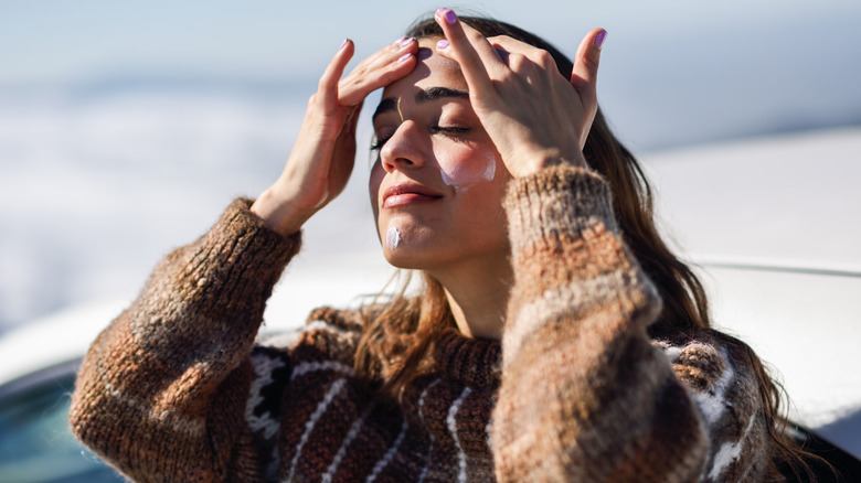 Woman applying sunscreen