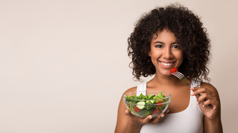 African American woman eating salad