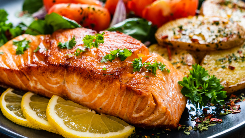 Salmon cooked with vegetables, lemon and herbs.