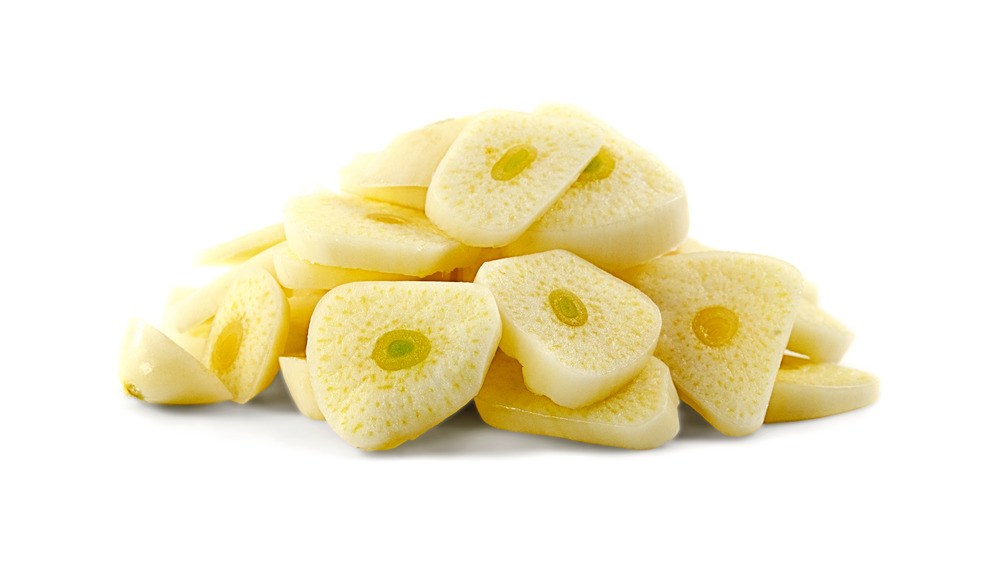 Fresh cut garlic on white background 