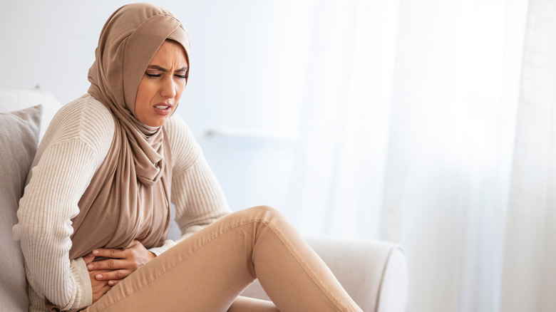 A woman holding her stomach