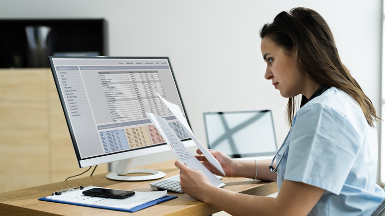 provider reading charts at computer