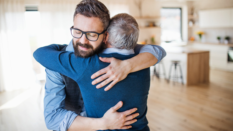 Two men hugging each other