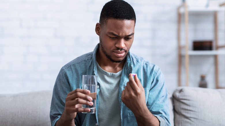 man taking pill