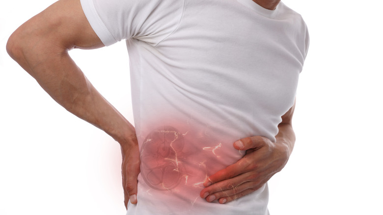 Man clutching side due to kidney pain