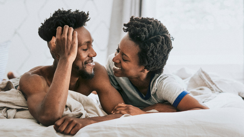 couple smiling in bed