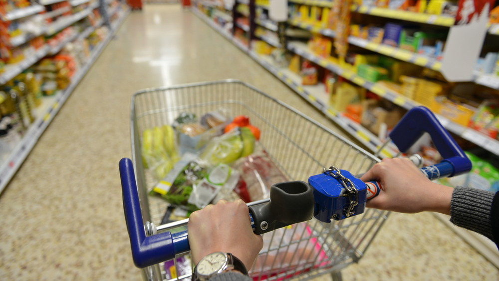 Woman pushing grocery shopping cart