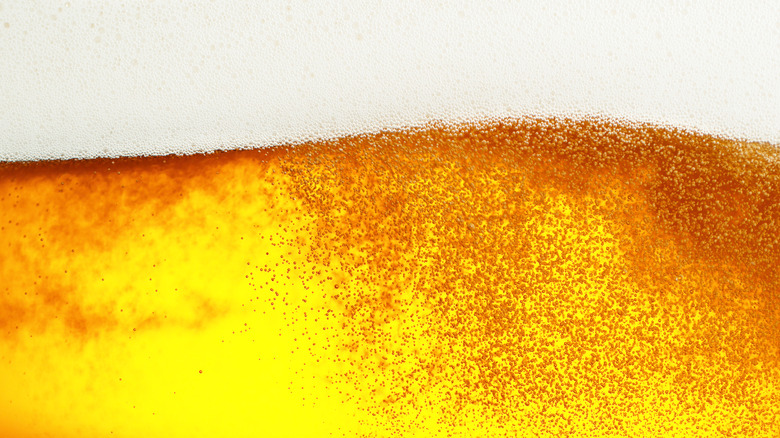 close up of golden-colored beer with a foam head 
