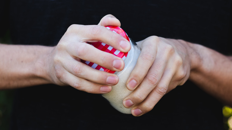 hands opening jar