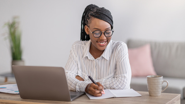 Woman with stylish glasses working from home