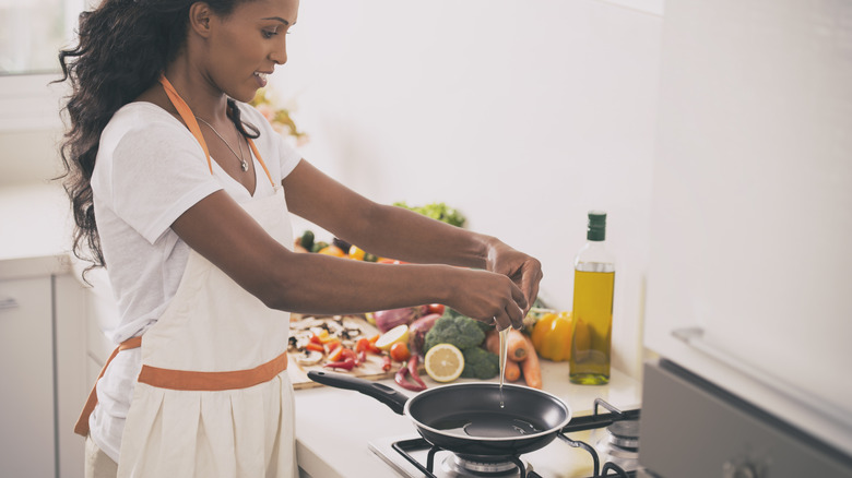 woman cracking eggs in bowl