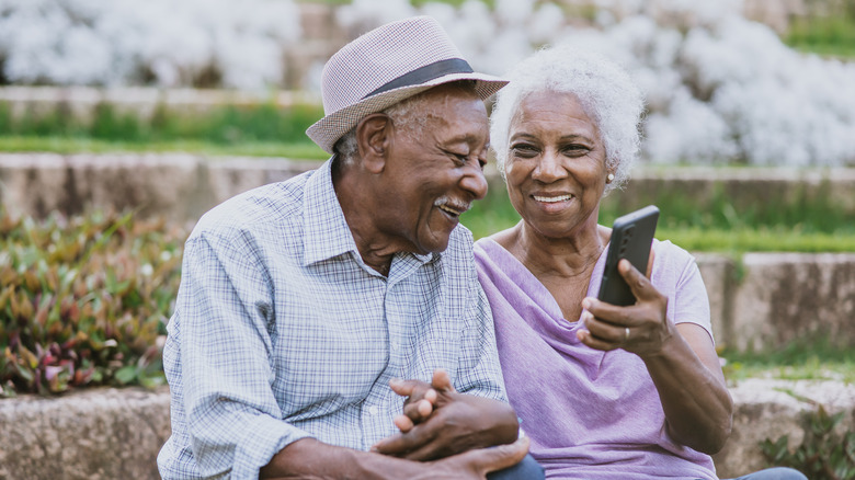 happy older couple sitting outside