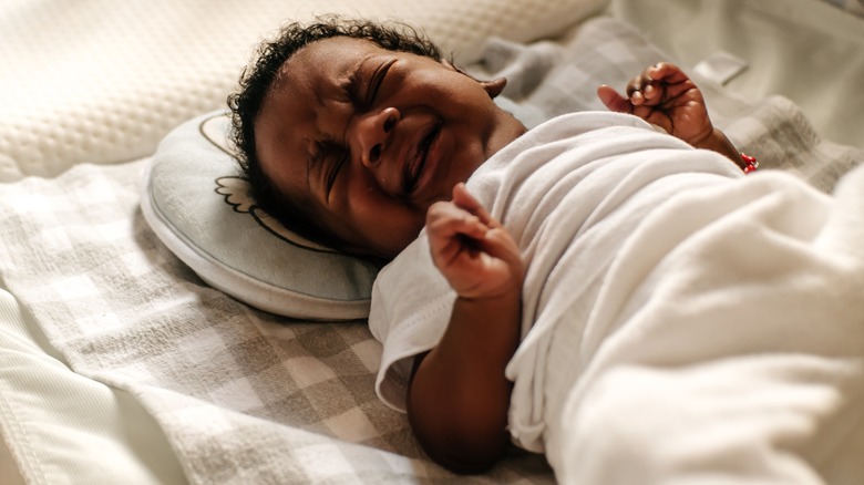 Crying baby in crib