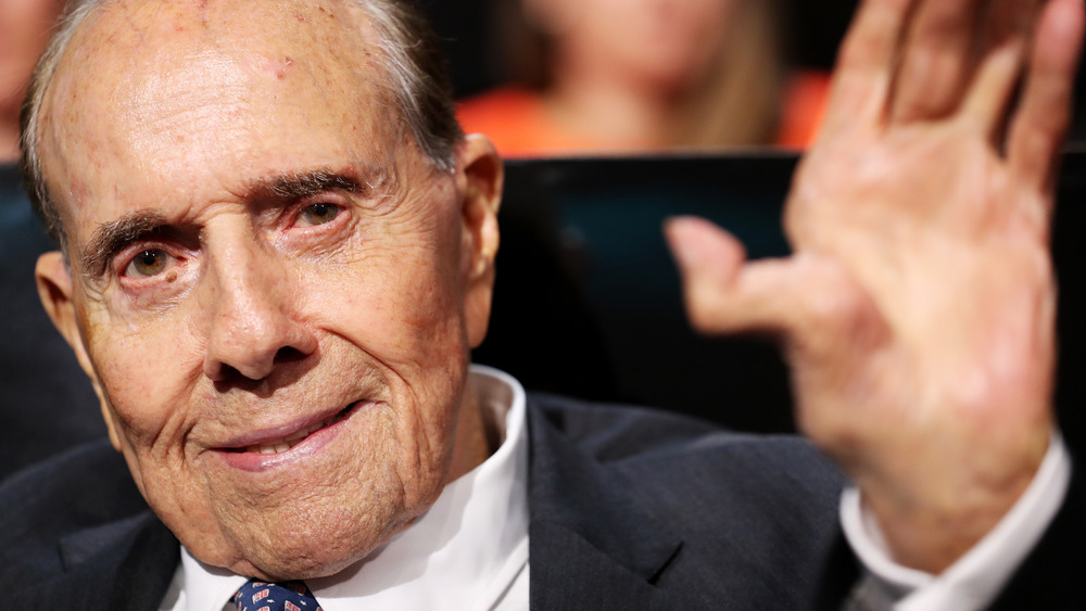 Politician Bob Dole waves to crown