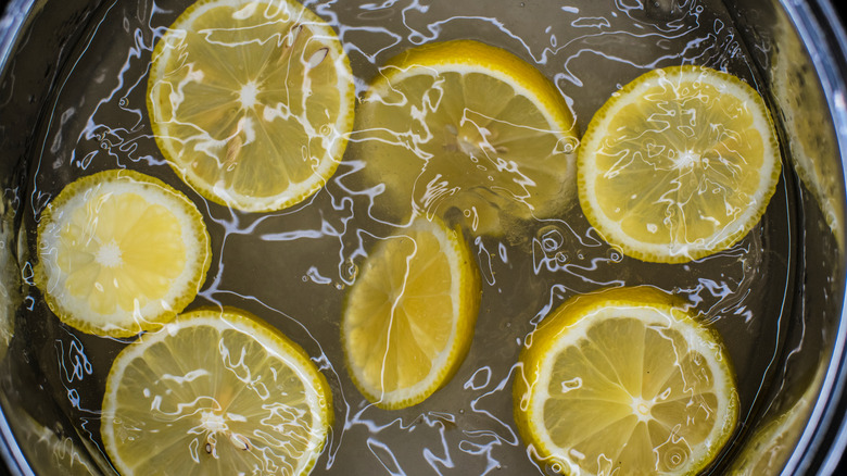 Lemon slices in boiling sugar water top view