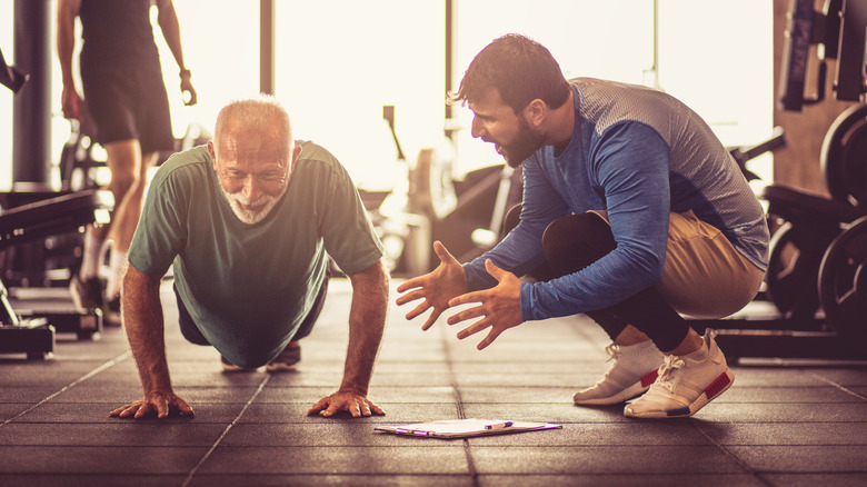 personal trainer with older man