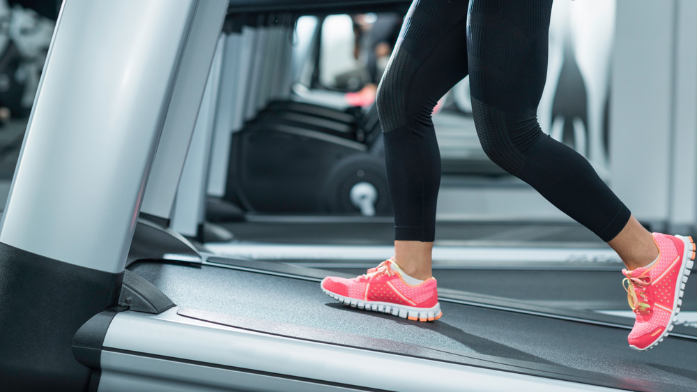 Woman using treadmill on an incline