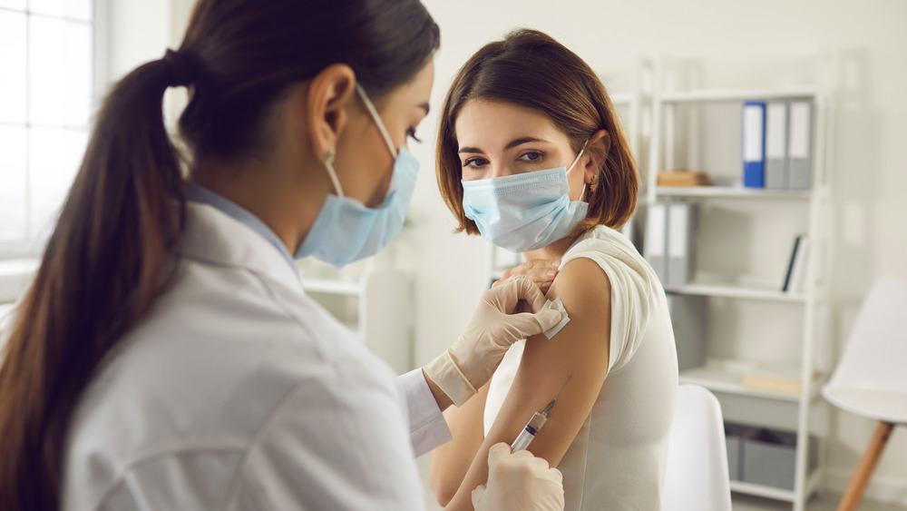 Doctor giving patient COVID-19 vaccine