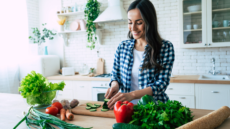 Woman is preparing vegetables in her kitchen