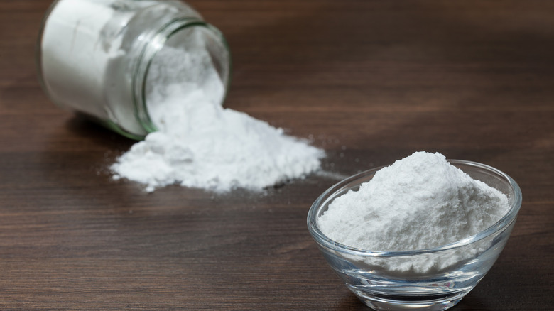 Baking soda on dark wooden table