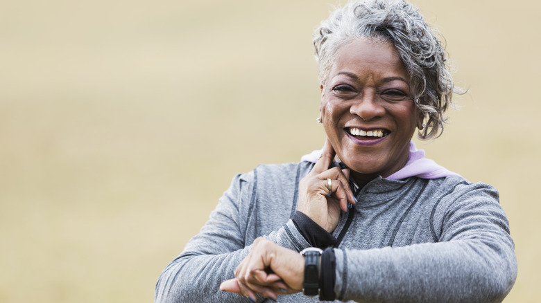 older woman exercising and checking her pulse