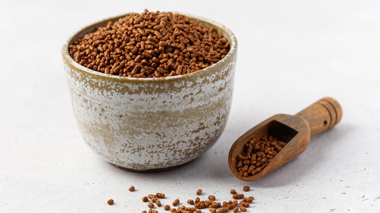 Bowl of tartary buckwheat seeds next to scooper