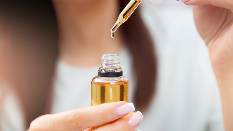 Excited woman holding olive oil