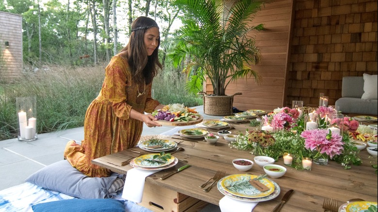 Woman setting dinner table