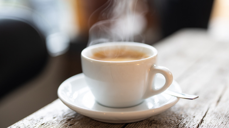 white cup of coffee on a wooden table