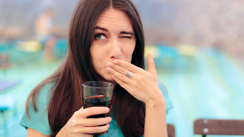 woman in a restaurant having hiccups