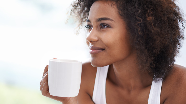 woman drinking from a mug